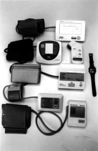 Photo of seven brands of home electronic blood pressure monitors which were tested by NCAC