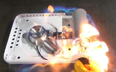 Photo of a portable gas stove catching fire due to gas leakage from a gas cartridge soon after ignition