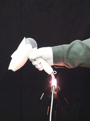 Photo of a hair dryer held by a hand, which is generating smaller sparks from the root of its cord