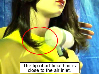 Photo of a scene when the tip of artificial hair of a doll is close to the air inlet