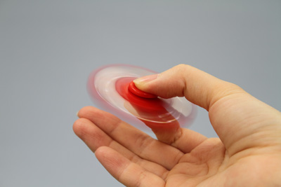 Photo of a fidget spinner being spun